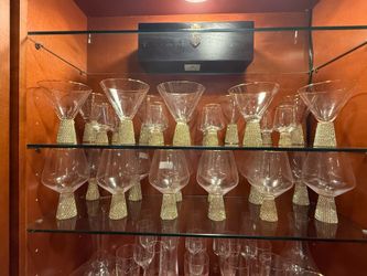 Elegant glassware with gold rim and sparkly rhinestone-studded base. Martini glasses and stemless glasses available. Great for entertaining.