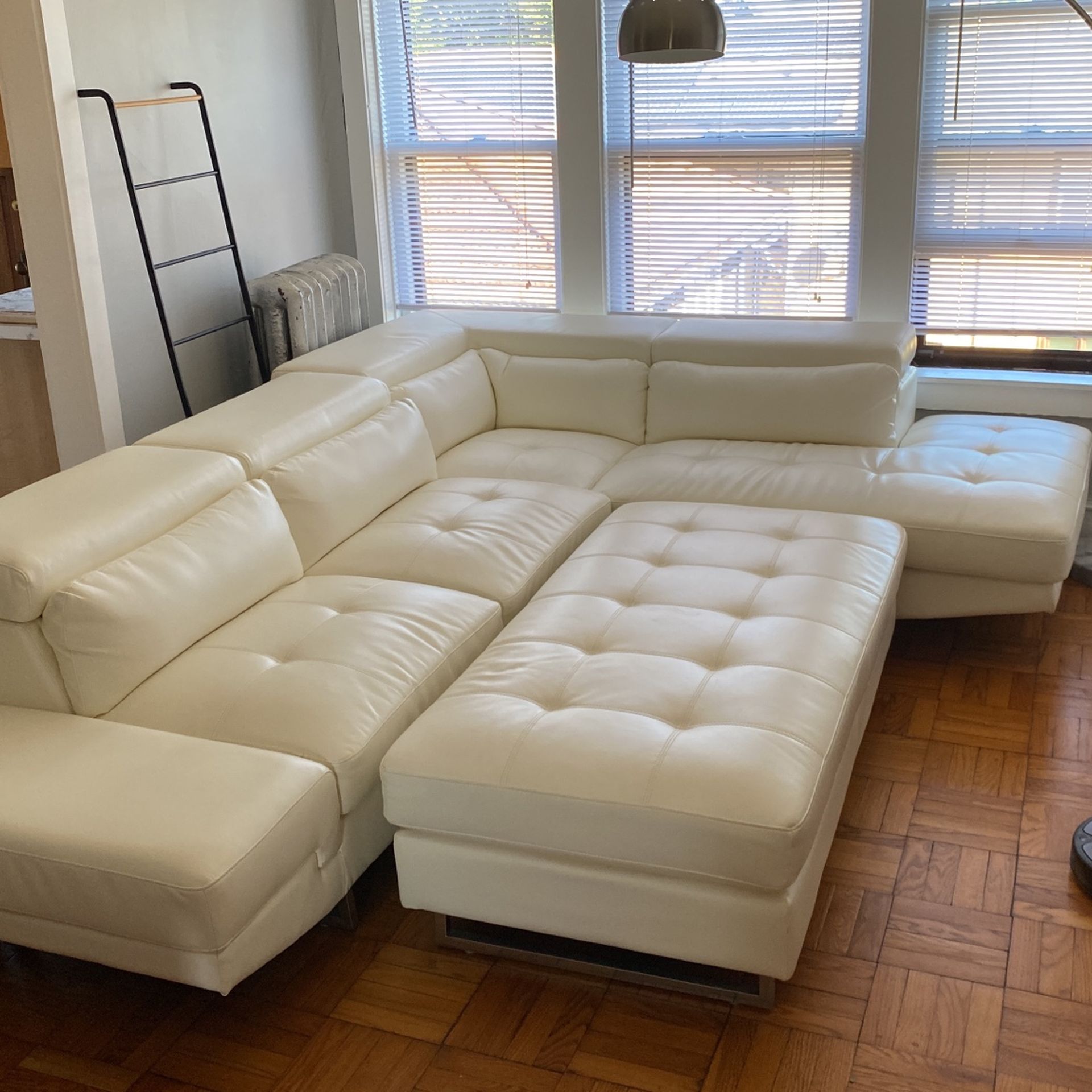 White 2-piece sectional with chase and ottoman