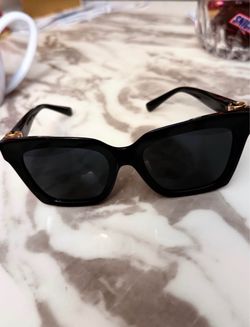 Dolce & Gabbana 0DG4498 square-frame sunglasses in black acetate with gold-tone accents.