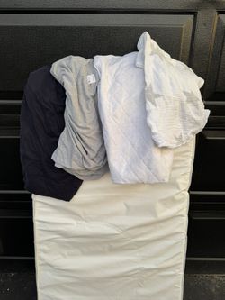 Crib mattress with sheets and protector