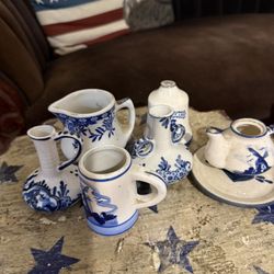 This is a collection of vintage Delft Blue miniature pitchers and vases. 