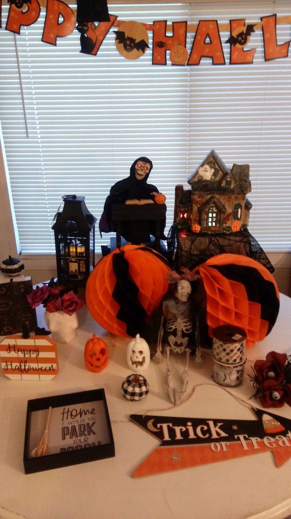Lots of vintage and new halloween decorations lighted lantern, haunted house with color changing lights,
