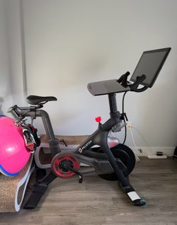 The Peloton Bike, Bosu ball, weights pink