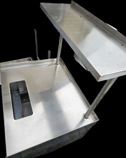 Stainless steel condiment station with trash bit cutout