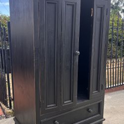 Spacious black Distressed wooden wardrobe with two doors and a bottom drawer.