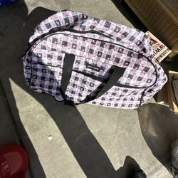 This is a Betsey Johnson designer pattern wheeled duffel carry-on bag