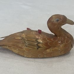 Vintage handmade corn husk duck ornament with red hanging string.