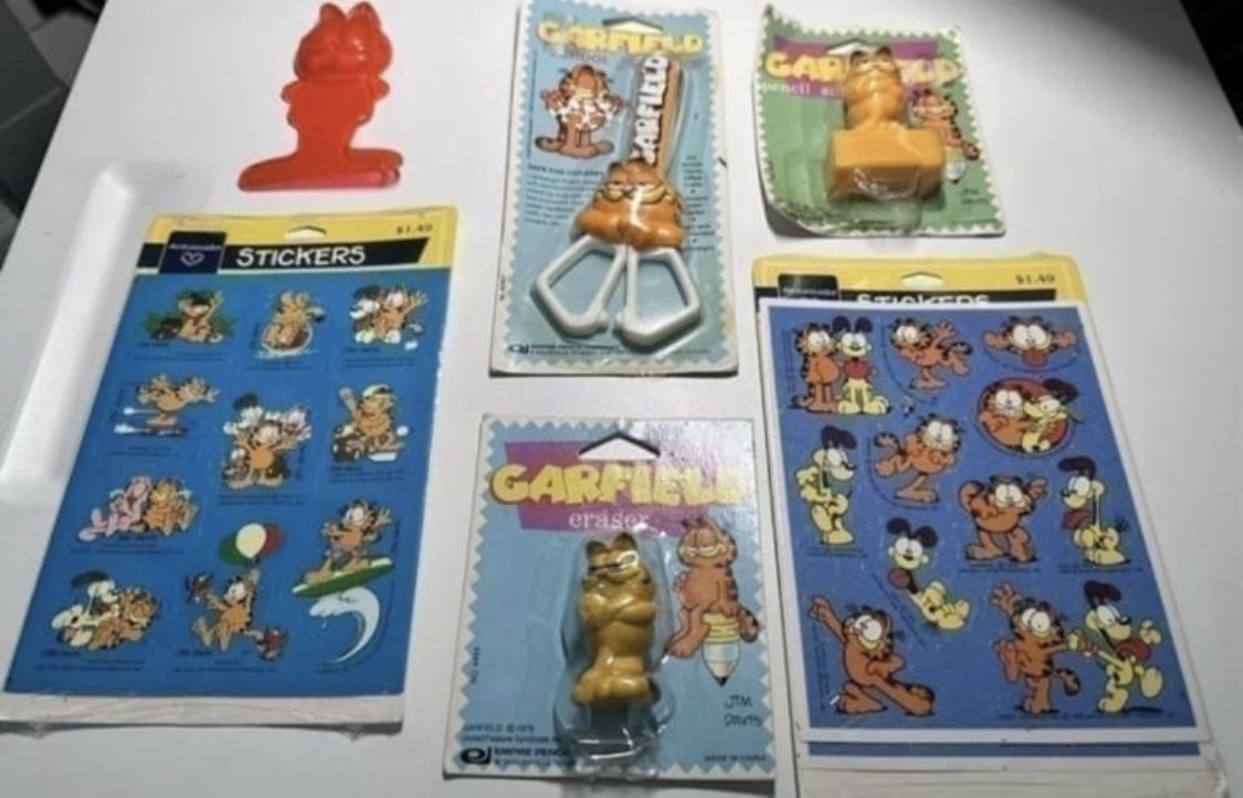 Garfield Lot Of 6 Scissors, Eraser, Pencil Sharpener Stickers And More  Items from 70’s. They are new but packaging shows wear. 5 of the items are in 