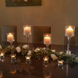 Head Table Greenery Wrapped In White Roses, 14 Total Tall And Short Candle Holder, 50 Tea Light Candle Holder.