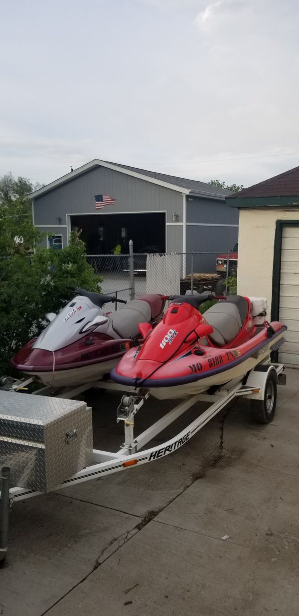 1999 red kawasaki jetski and 2000 maroon kawasaki jetski w/trailer