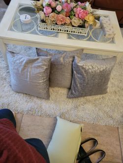 Set of three metallic colored decorative pillows.
