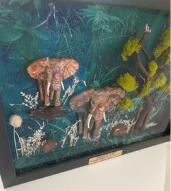 Very unique 1 of a kind 3-D effect beautiful hand sculpted and hand painted mother and baby elephant enclosed in a very expensive shadow box.   Set in