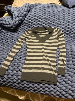 Lightweight knit V-neck sweater with horizontal stripes.