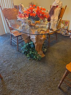 Table set lion carved out of one piece of wood, three big lion heads, one of a kind, very, very heavy, four chairs that match it.And the top is a very