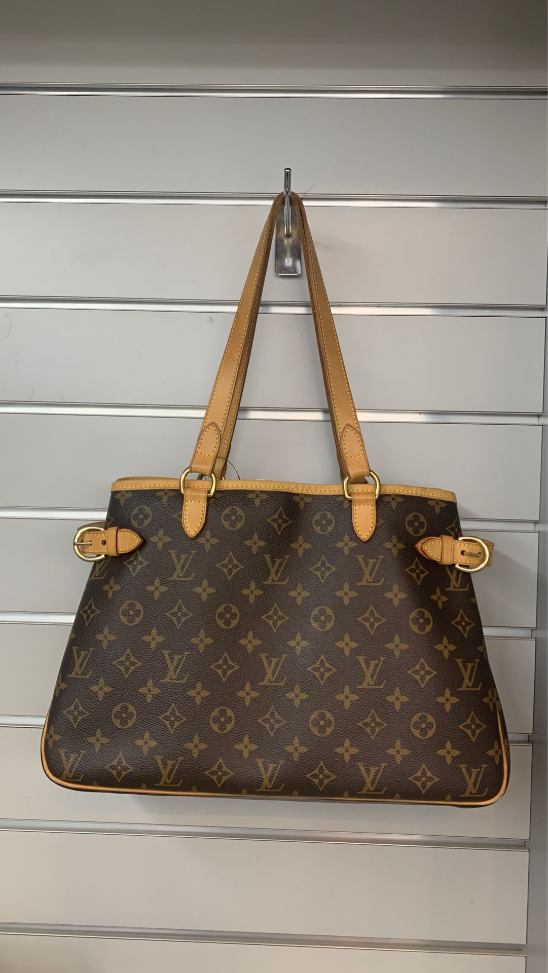 Louis Vuitton certified authentic hand bag peruse.
