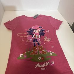 This pink T-shirt features a graphic design of an animated cowgirl with the inscription "Austin Texas", similar to personalized products for Western t
