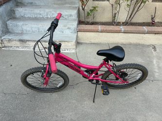 A pink and black BCA 20 crossfire 6 speed mounting bike
