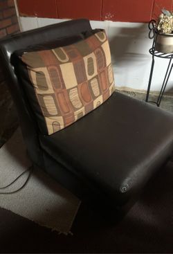 Leather chair with attached fabric face back cushion.