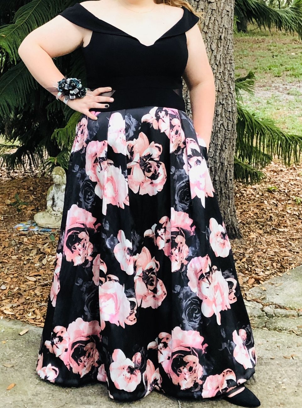 Prom dress from David’s Bridal. Has pockets. Picture does it no justice. Paid $299. There is 2 small sheer cut outs on the sides where the floral