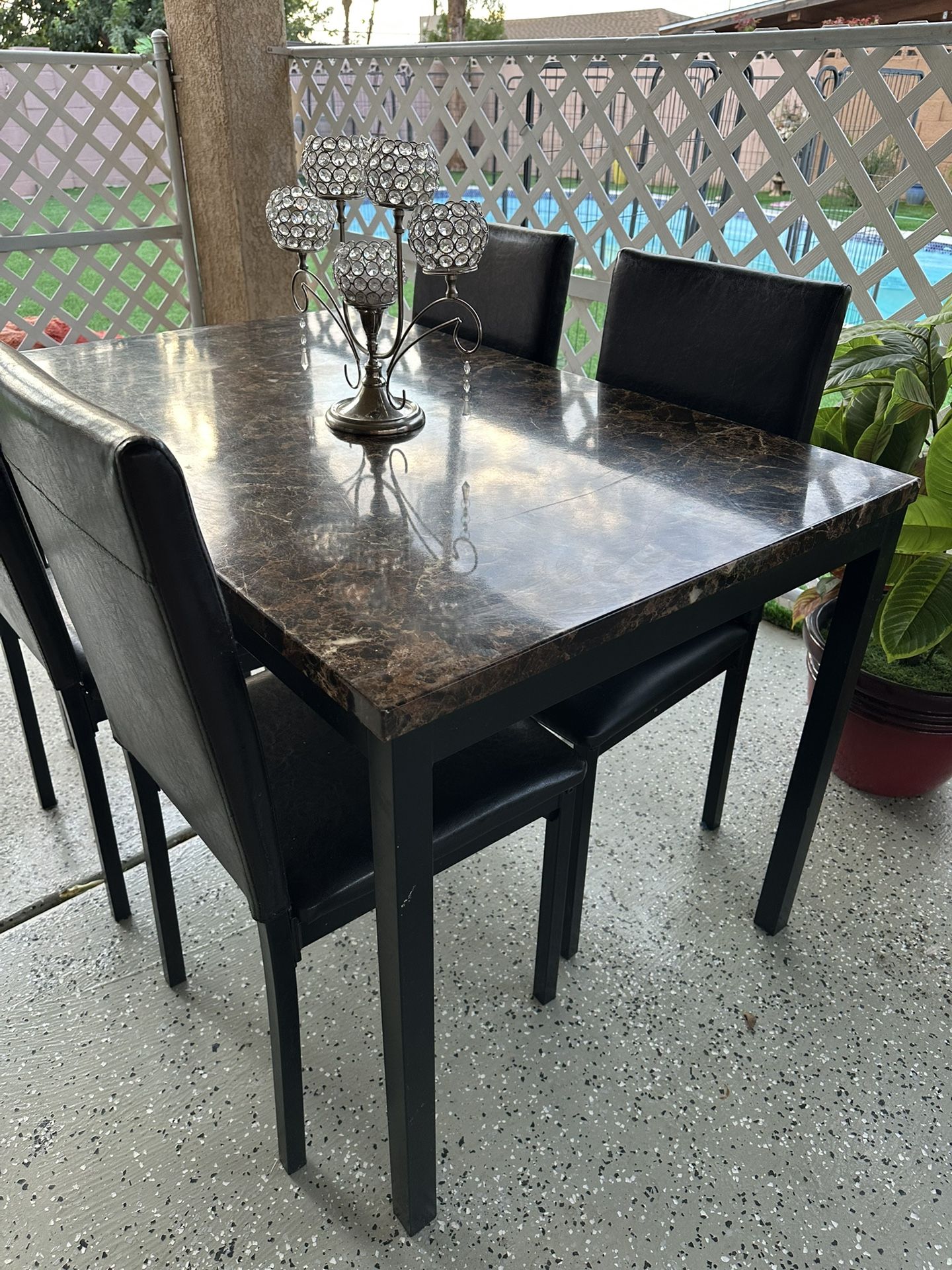 Black marble dining table set with 4 leather chairs.    πππ