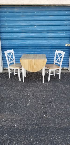 Photo Small table with fold out leaf & 2 chairs. Table measures approx: 30 wide x 30 deep x 30 tall.