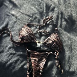 brown and cream animal print triangle bikini set with tie details and gold-toned beads. 