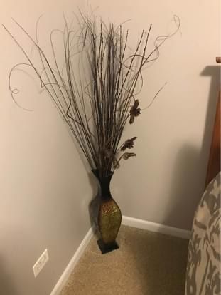 Decorative metal vase with twigs