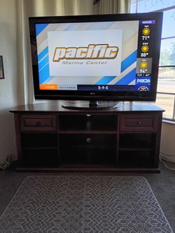 Packaged deal....55" color tv, remote with a  60" entertainment center