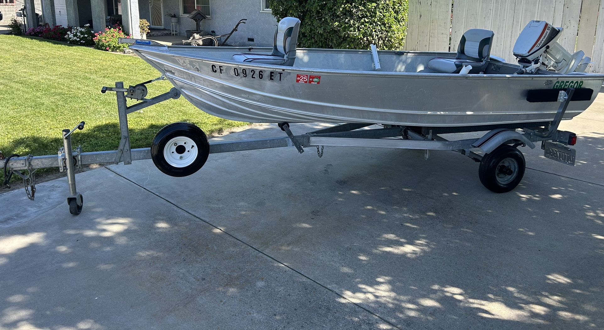 12’3” Gregor Aluminum Fishing Boat and Trailer with A Johnson 15 Horsepower Two Stroke Motor