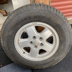 Primewell Valera HT tire mounted on a 5-spoke 15” OEM alloy wheel for a Jeep Liberty