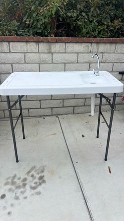 Fish cleaning table with faucet and drain