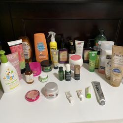 Big random bundle of toiletry items and personal hygiene products, make up, candle, vitamins.