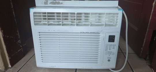 GE (General Electric) brand window air conditioner with a digital control panel.