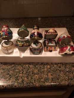 Set of 5 brand new ceramic handpainted heavy ornaments.Each open up like a trinket box and have individual themes that spin to music.Music and motion