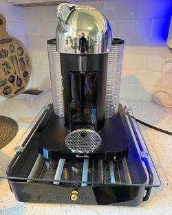 Nespresso coffee machine with frother and cup case