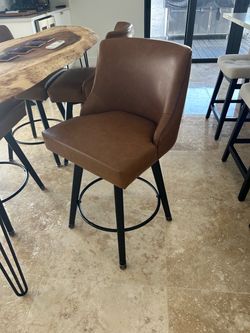 4 caramel color swivel bar stools