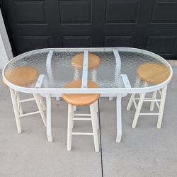 Glass patio table with swive topl bar stools Minor cleaning needed on chairs white surface