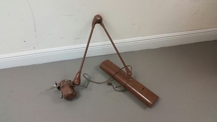 Clamps on sewing table or craft table, swivelt and articulates.