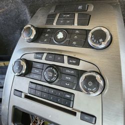 Radio and climate control panel for a 2010-2012 Ford Fusion. 