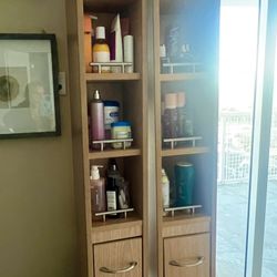 Two bathroom storage cabinets