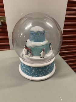 Musical  snow globe featuring penguins and an igloo