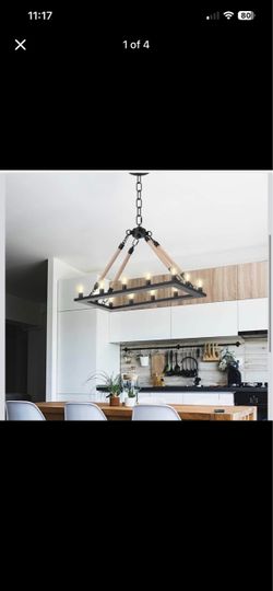 Modern industrial chandelier is constructed with a black metal rectangular frame and four rope-wrapped connection rods. This 10-light fixture has a to