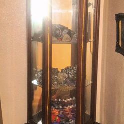 Tall curio with mirror , glass shelves, bottom storage and interior  light