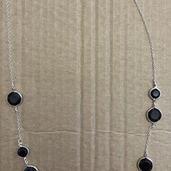  Silver toned necklace with black stones.