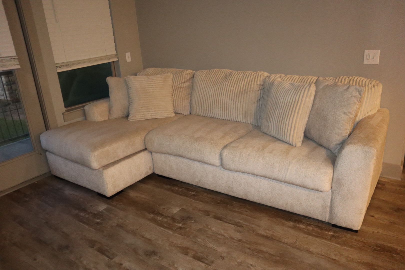 cream/beige colored L shaped sectional couch