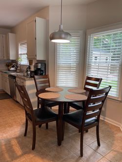 Dark wood drop leaf dining table and 4 chairs