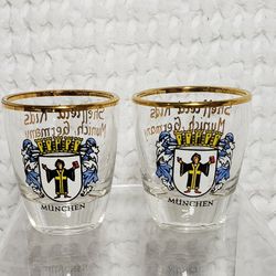 Sheffield kids Munich Germany glass shot glasses . Set of 2 that measures 2" H X 2 1/2" W . Good condition and smoke free home. 