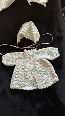 Hand crochet baby sweater with matching hat.