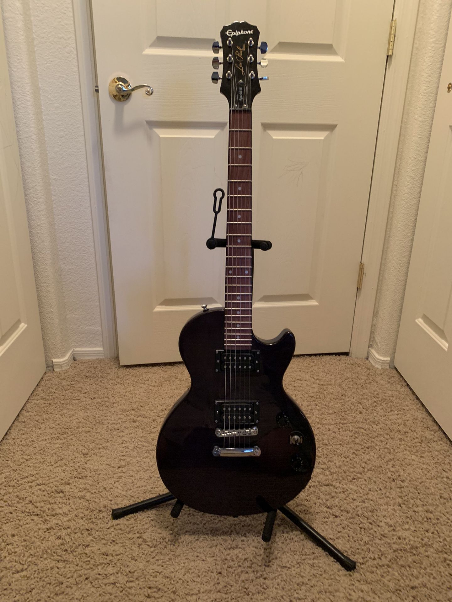 Epiphone Electric Guitar  with a stand and amplifier 