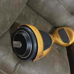 Sleek Gold Hoverboard. Black Foot Pads And Wheels .